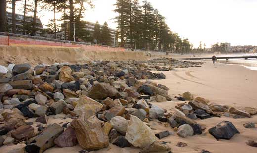The cut made by the swell excavated the beach quite close to the seawall. Council was quick to erect a barrier along the top of the seawall so careless tourists would not lose their balance and topple onto the rocks below and, probably, to protect themselves from law suits had this happened.