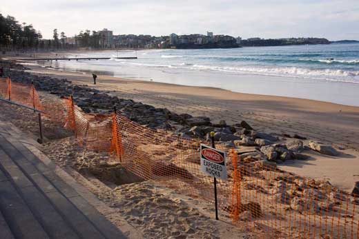 The long view, looking north. You can see the original height of the beach from the embankment that has been cut close to the esplanade. That’s a lot of sand that was scooped out and carried off by the swirling, crashing waters. It is as if the Sea God had moved its great hand to take back what it had lent to the land. The rocks that litter the foreground had been dumped there by Manly Council 20 or so years ago to stabilise the beach against events such as this. They dissipate the sea’s energy as it crashes and swirls around them, reducing its erosive power. Apparently, the idea worked.