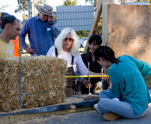 Huff'N'Puff's Susan makes a measurement to size a strawbale to fit. 