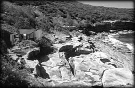 crater-cove The view eastward along the rocky shorline of Crater Cove reveals the Men's hut.
