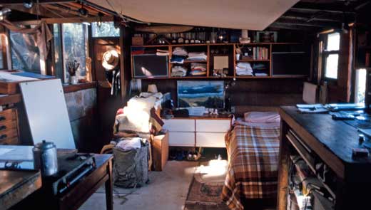 crater-interior2_1987 The simple needs of life are demonstrated in this interior image of Simon Flynn's shack in 1987. Note the artwork depicting a view over the harbour.