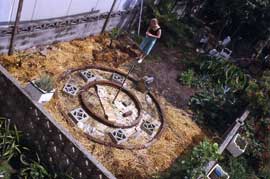 mont-constructing The circular path has been layered with newspaper as a weed barrier prior to spreading bark chips. The surrounding garden has been sheet mulched ready for planting.